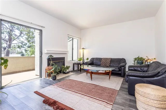 a living room with furniture a fireplace and a table