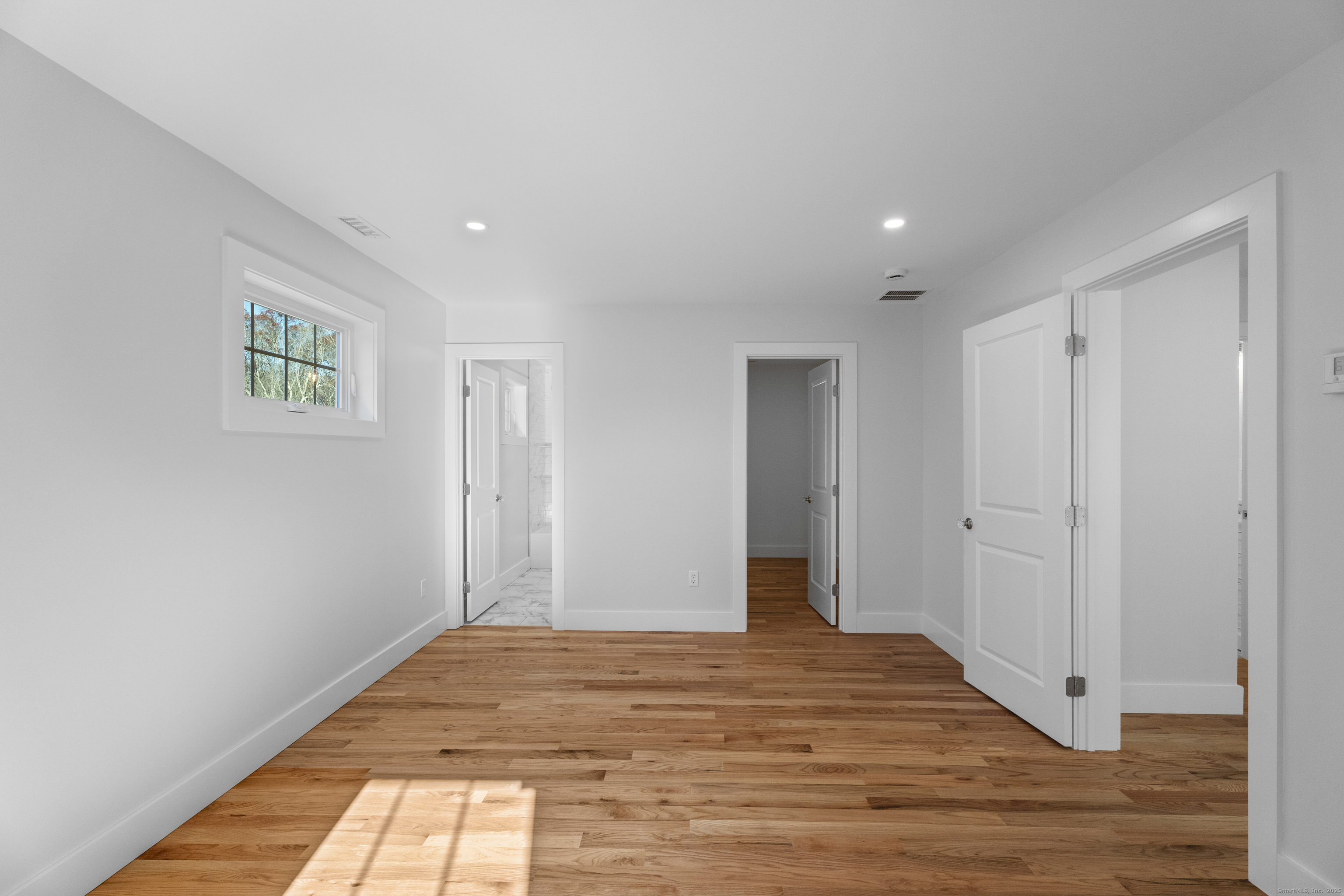 a view of a room with wooden floor and closet