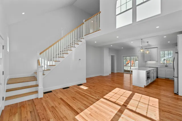 a view of a room with wooden floor and a window