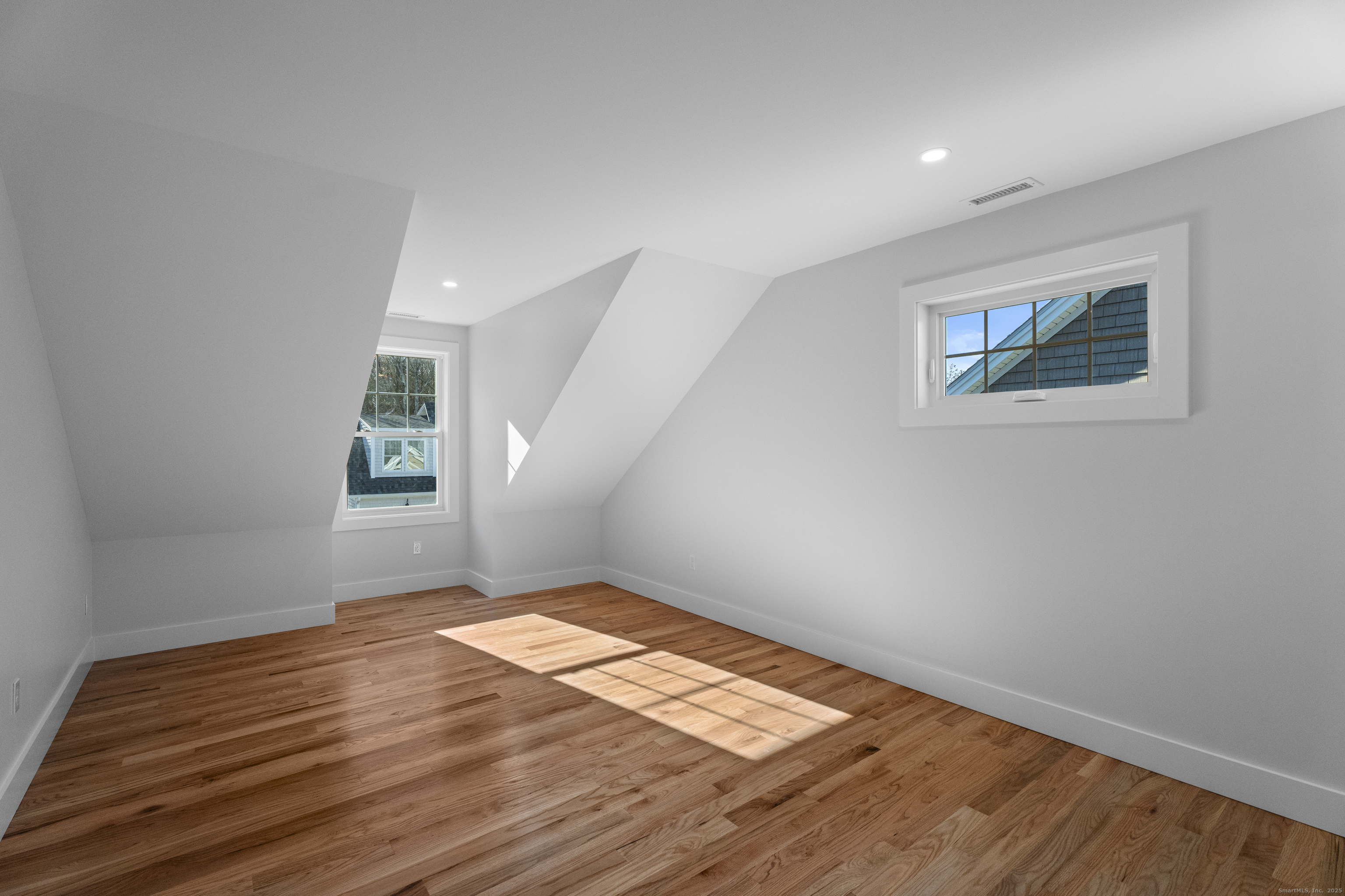 34 Ivy Hill Road, Unit 34 Waterford, CT 06385 - Photo 15 of 33 wooden floor in an empty room with a window