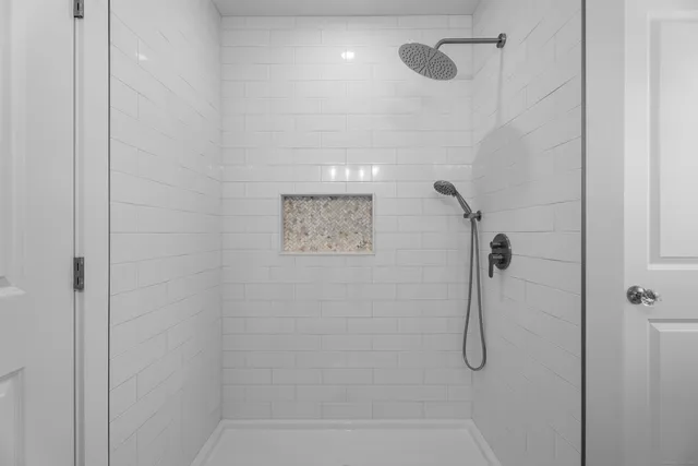 a view of room with wooden floor and white walls