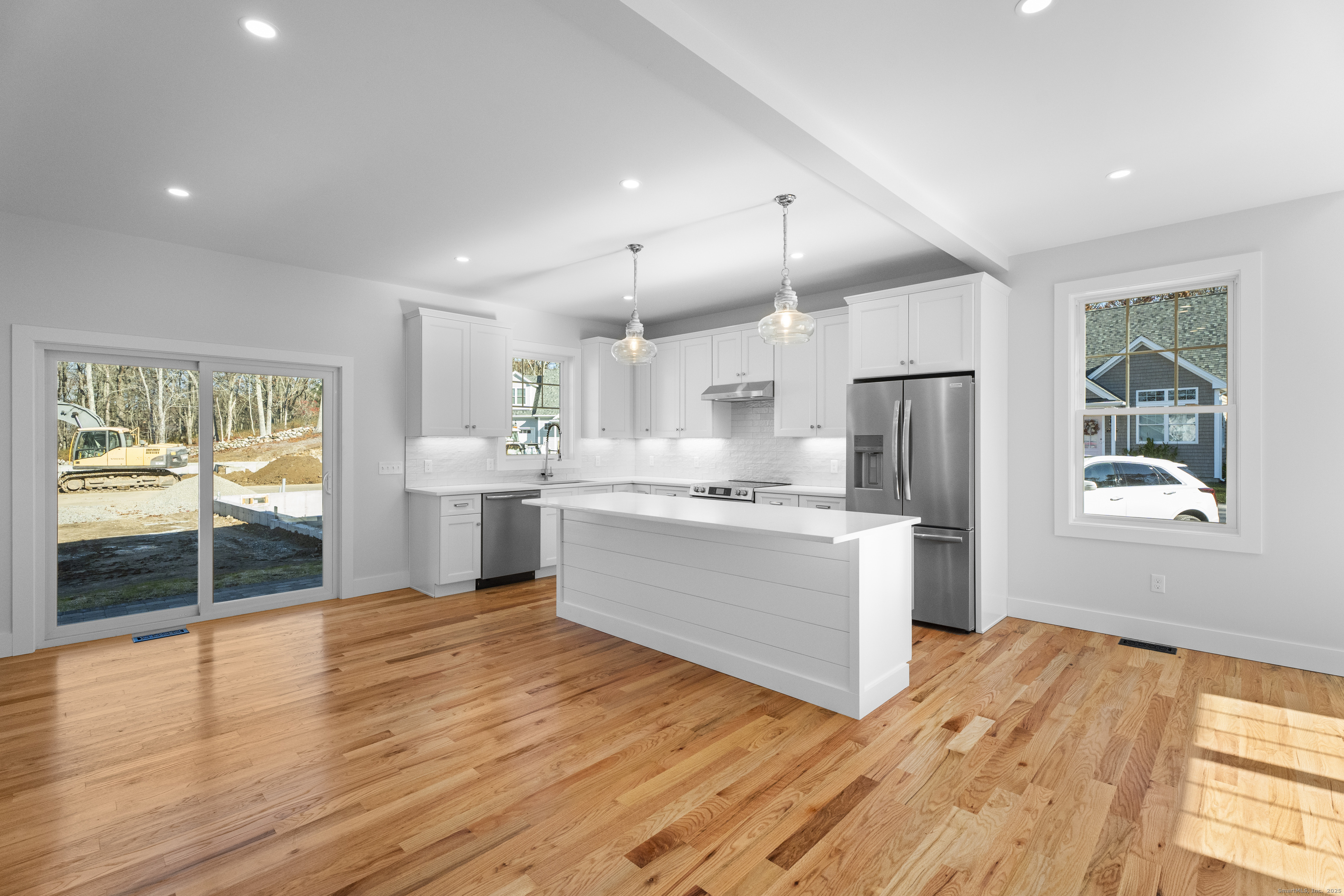 34 Ivy Hill Road, Unit 34 Waterford, CT 06385 - Photo 5 of 33 a kitchen with stainless steel appliances kitchen island wooden floors and white cabinets