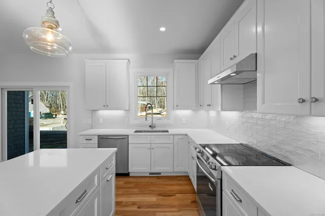a view of a kitchen center island wooden floor and center island