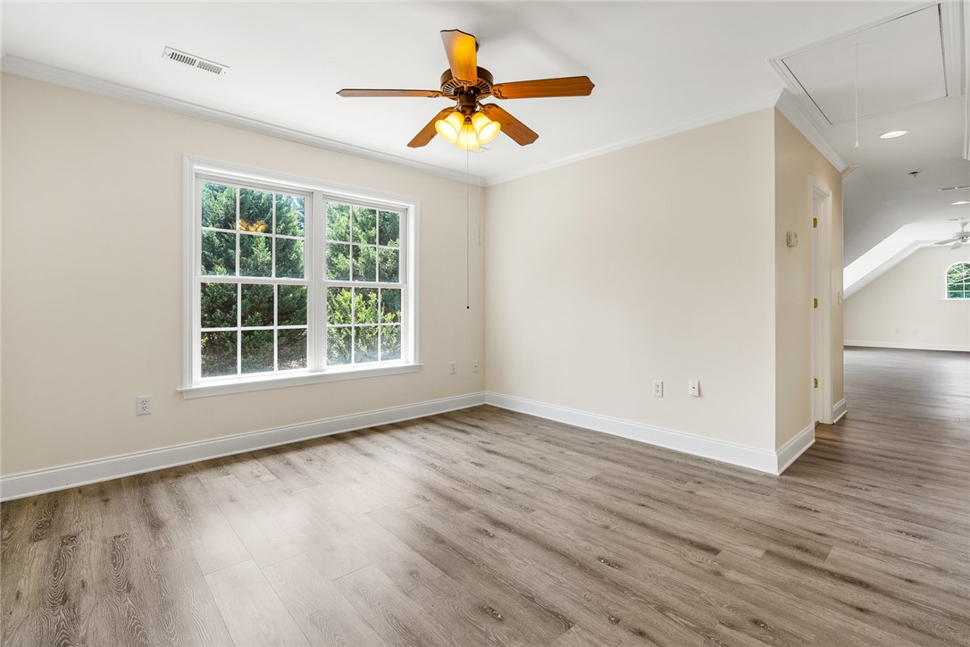135 Sunset Bay Boulevard Seneca, SC 29672 - Photo 36 of 50 A versatile bonus room features wide plank flooring and a ceiling fan, perfect for any use.