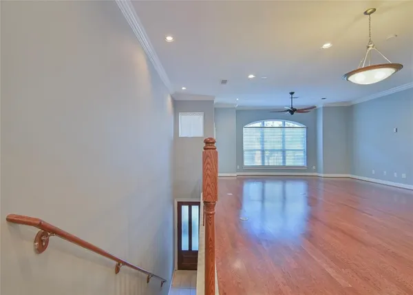 a view of a room with wooden floor and window