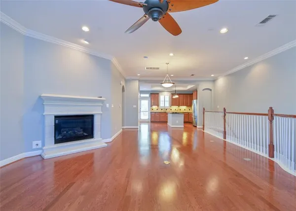 a view of a room with entryway wooden floor fire place and windows
