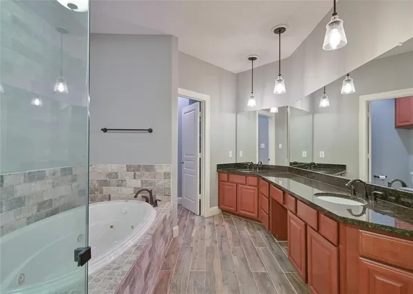 a large spacious bathroom with a large tub and sink