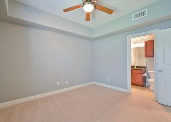 wooden floor in an empty room and a bathroom