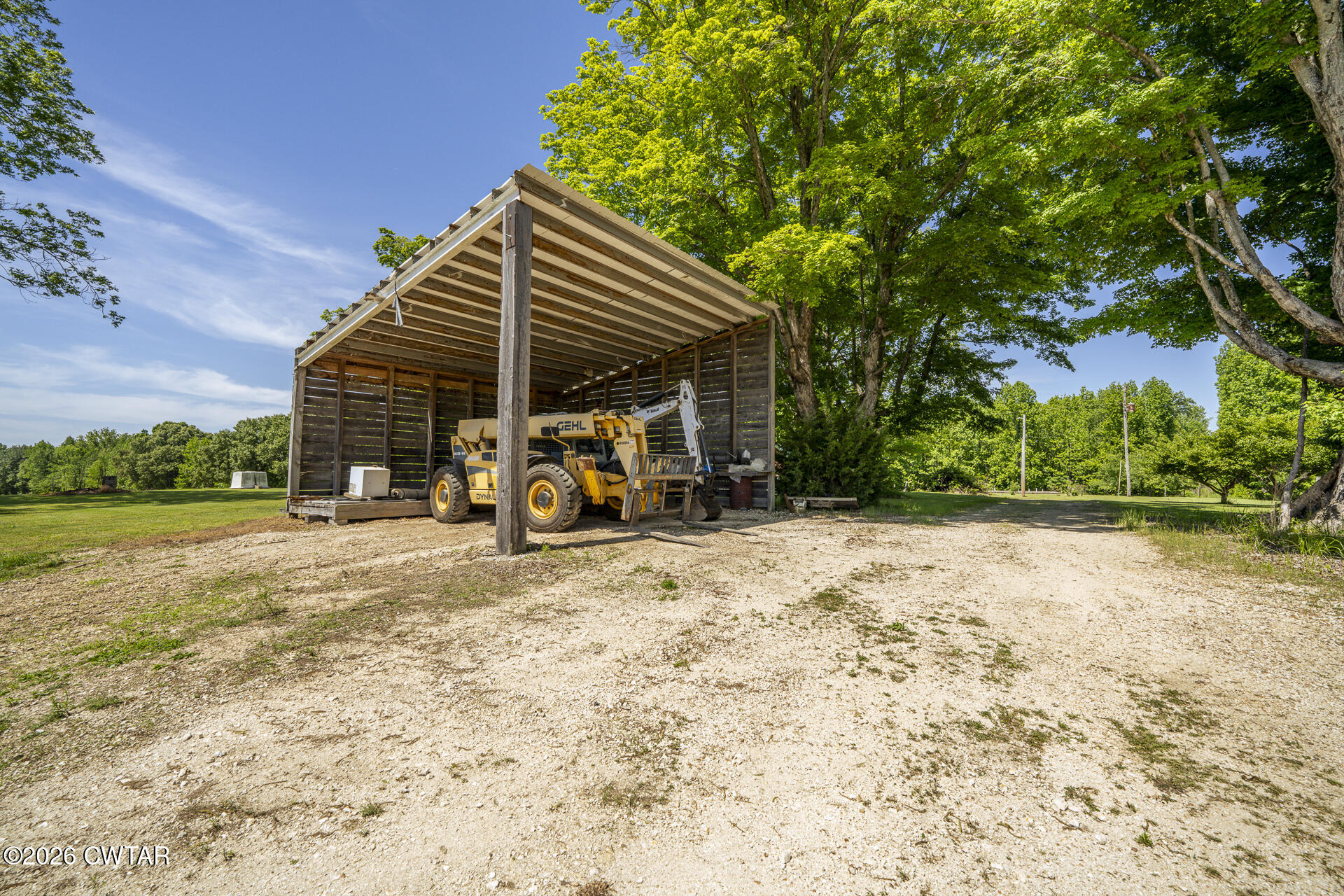 61 Con Pennington Road Kenton, TN 38233 - Photo 39 of 46 a view of a chair and tables in the patio next to a yard