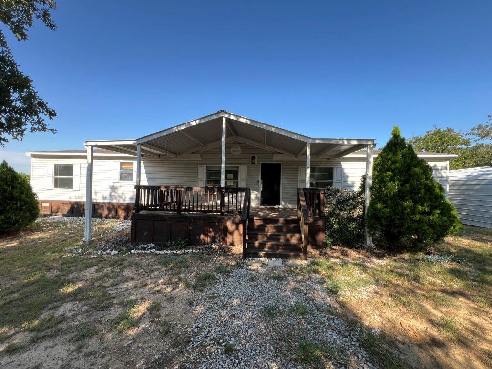 a view of a house with backyard porch and sitting area