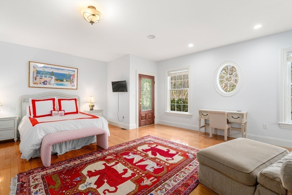 80 Loring Road Weston, MA 02493 - Photo 20 of 28 a bedroom with a bed and a table in it