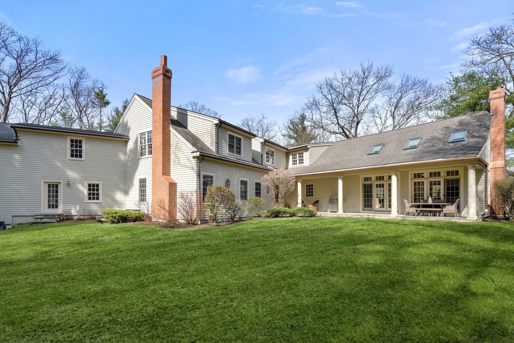 80 Loring Road Weston, MA 02493 - Photo 28 of 28 a front view of a house with a garden