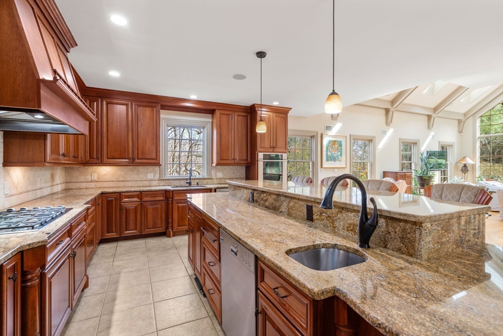 80 Loring Road Weston, MA 02493 - Photo 8 of 28 a kitchen with granite countertop a sink a counter space appliances and cabinets