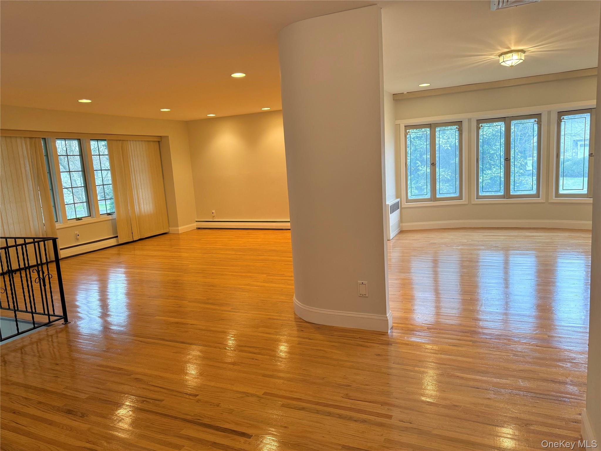 30 Dogwood Road Albertson, NY 11507 - Photo 7 of 20 Living area featuring polished hardwood floors, recessed lighting, and large windows providing natural light