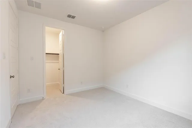 a view of a house with backyard and wooden fence