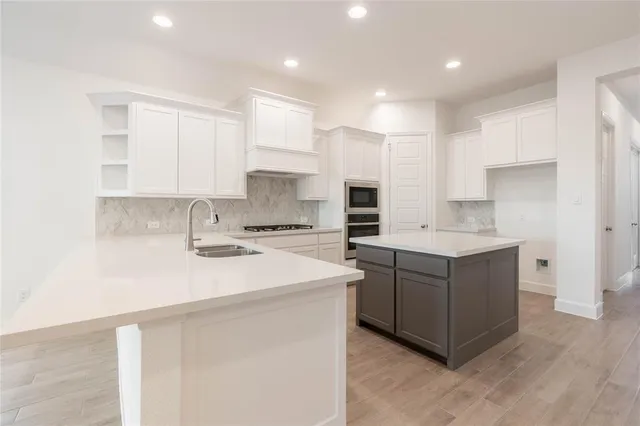 a view of a kitchen with a stove cabinets and wooden floor