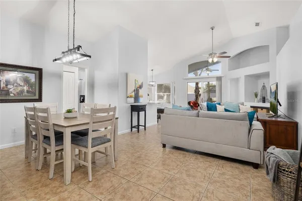a kitchen with granite countertop a sink stainless steel appliances and white cabinets