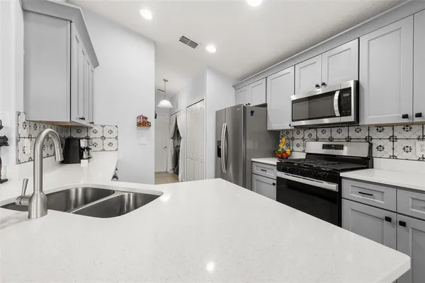 a kitchen with a sink stove and microwave