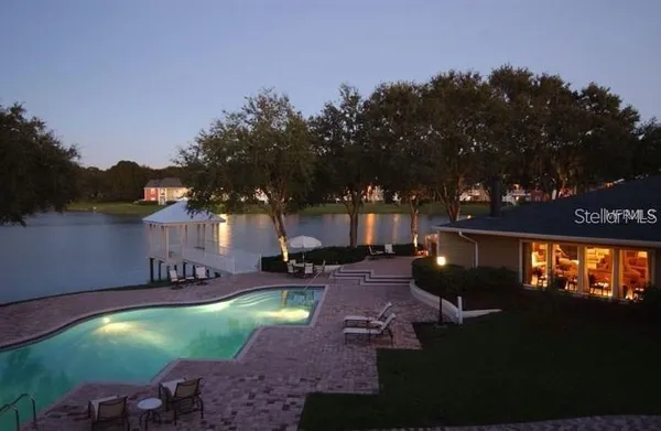 a swimming pool with outdoor seating and yard