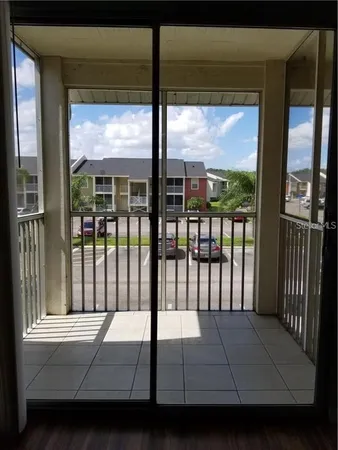 a room with a bed and a large window