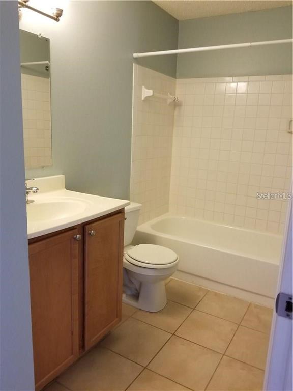 803 Lake Haven Square, Unit 202 Brandon, FL 33511 - Photo 8 of 17 a bathroom with a sink a toilet and shower