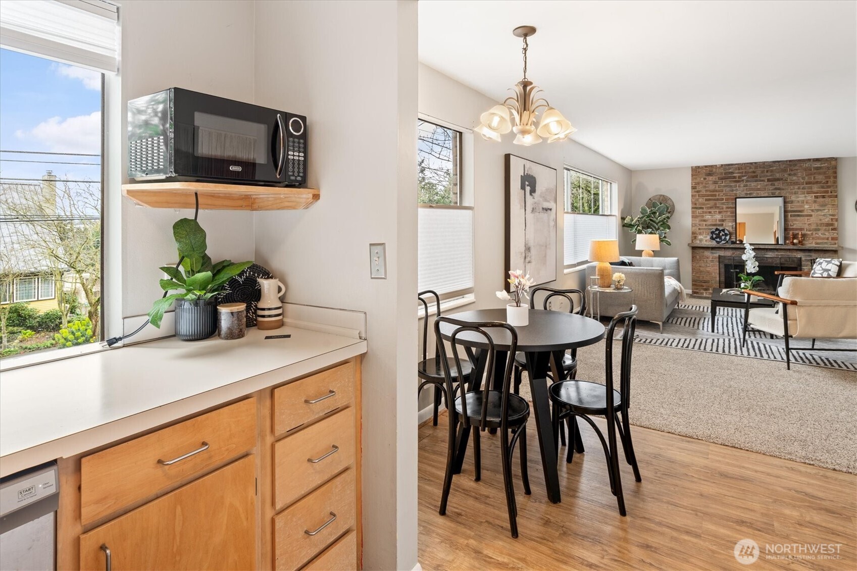 5638 3rd Avenue Northwest Seattle, WA 98107 - Photo 15 of 40 a dining hall with stainless steel appliances kitchen island granite countertop a table and chairs in it