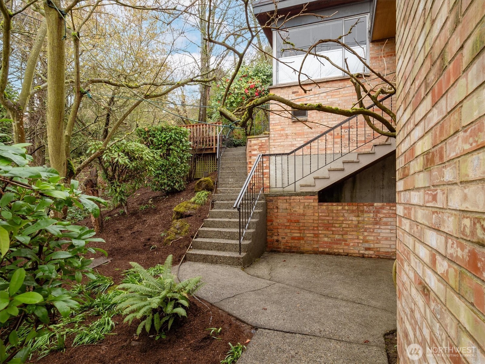 5638 3rd Avenue Northwest Seattle, WA 98107 - Photo 2 of 40 a balcony with stairs and a potted plant