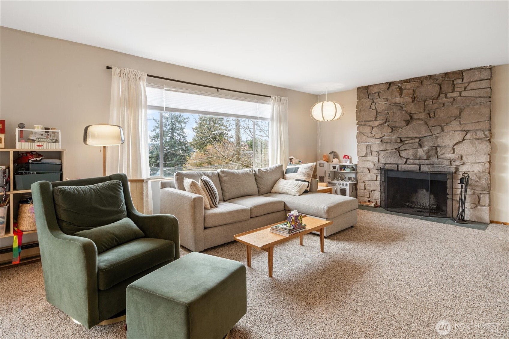 5638 3rd Avenue Northwest Seattle, WA 98107 - Photo 21 of 40 a living room with furniture a large window and a fireplace