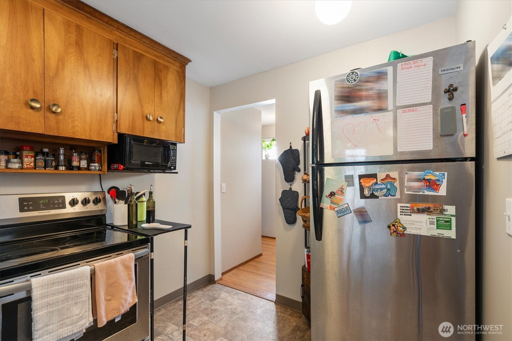 5638 3rd Avenue Northwest Seattle, WA 98107 - Photo 38 of 40 a kitchen with stainless steel appliances granite countertop a refrigerator and a stove top oven