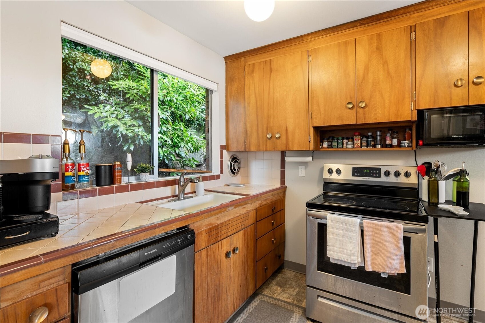 5638 3rd Avenue Northwest Seattle, WA 98107 - Photo 39 of 40 a kitchen with a sink a stove and cabinets