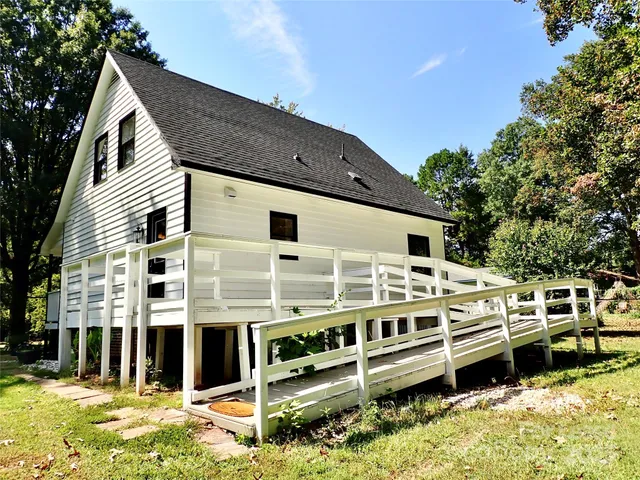a view of a house with a backyard