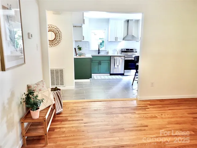 a view of a kitchen with kitchen island dining table and wooden floor