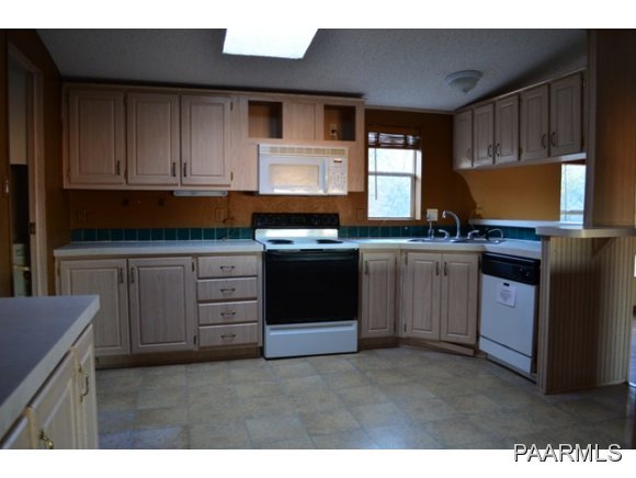 740 North Tubac Road Prescott, AZ 86303 - Photo 12 of 20 a kitchen with stainless steel appliances granite countertop a stove a sink dishwasher and a microwave oven