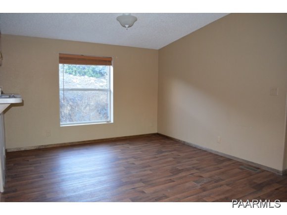 740 North Tubac Road Prescott, AZ 86303 - Photo 6 of 20 a view of an empty room with wooden floor and a window