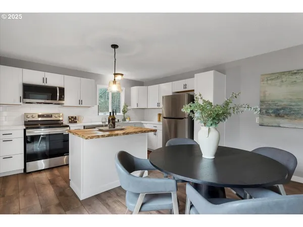 a kitchen with a table and a refrigerator