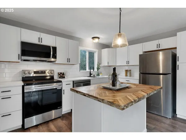 a kitchen with kitchen island a counter space a sink and a stove