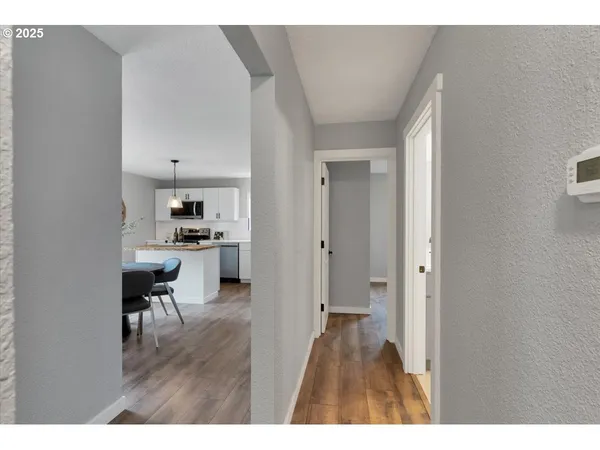 a open kitchen with cabinets and wooden floor