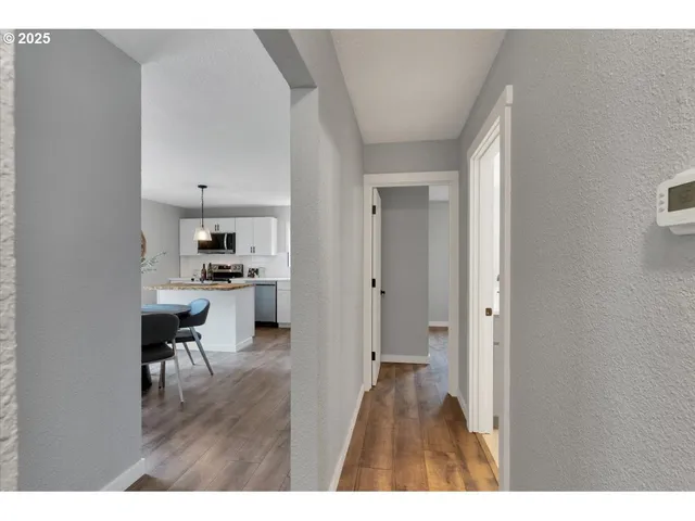 a open kitchen with cabinets and wooden floor