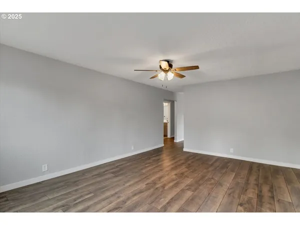 a view of an empty room with wooden floor