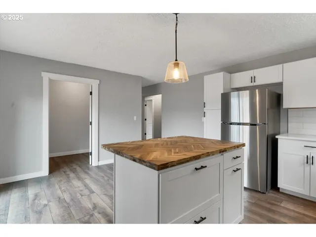 a kitchen with a counter top space and refrigerator