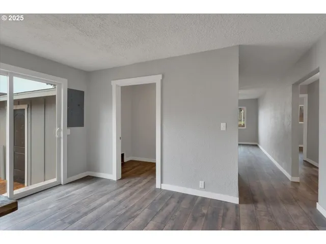 a view of an empty room and wooden floor