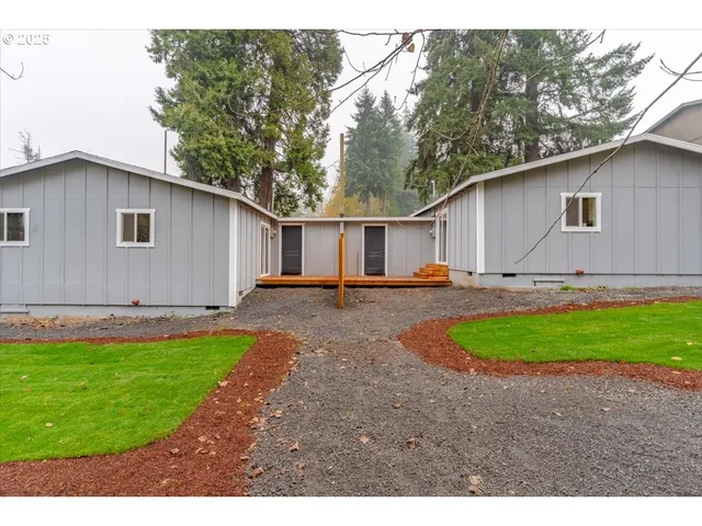 a backyard of a house with yard and outdoor seating