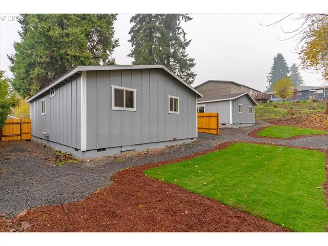 a house with green field in front of it