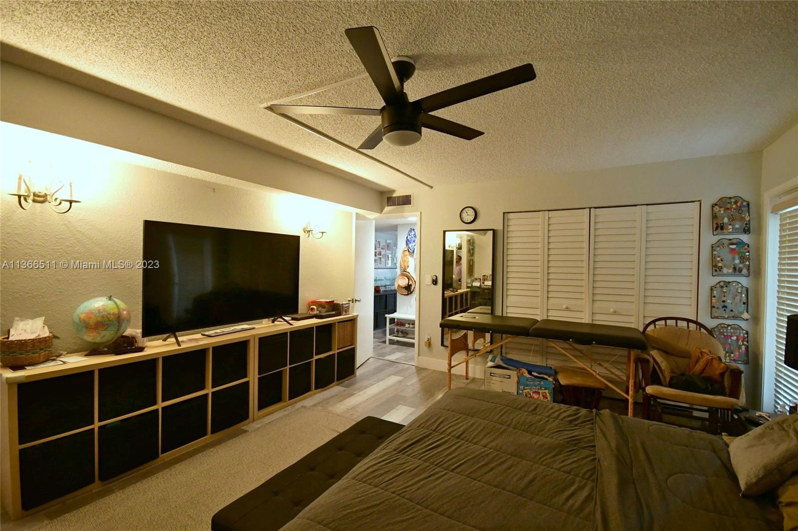 a view of a livingroom with furniture and a flat screen tv