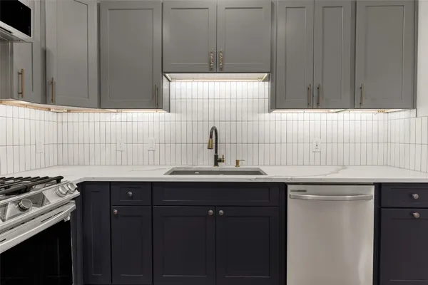a kitchen with a sink and cabinets