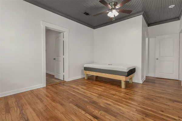 a room with a bed and a ceiling fan