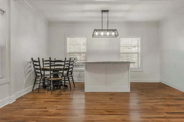 a view of dining room and kitchen with furniture wooden floor and chandelier