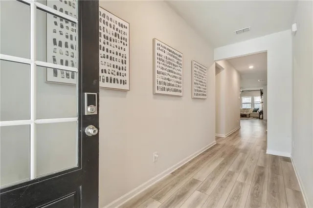 a view of hallway with wooden floor