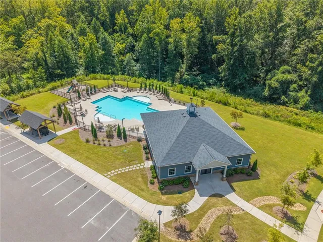 an aerial view of a house with swimming pool garden and patio