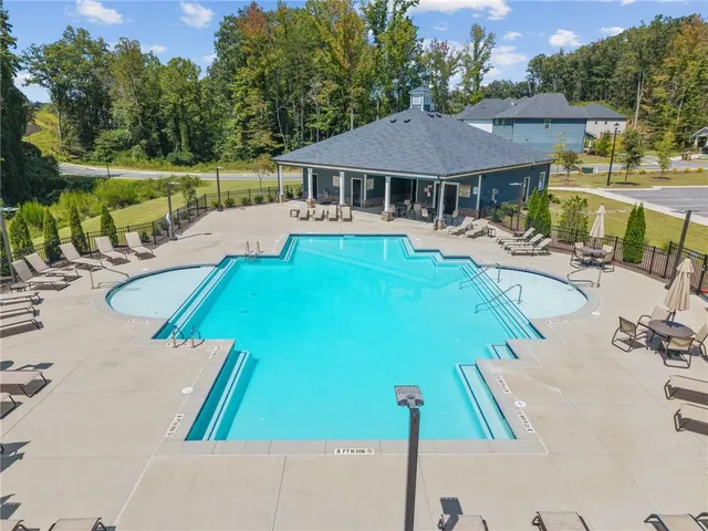 a view of swimming pool with seating area and garden